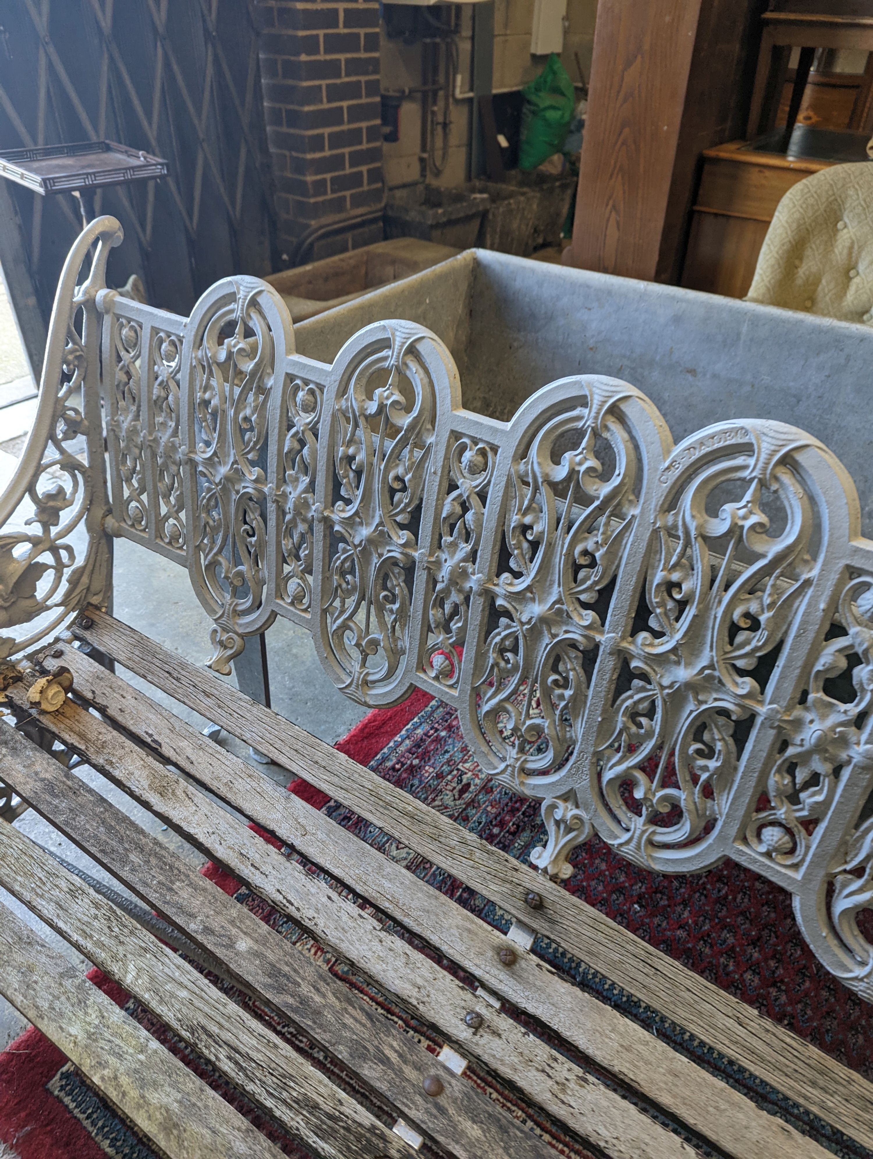 A Victorian Coalbrookdale cast-iron garden bench, length 156cm, depth 68cm, height 94cm (re-painted and seat in need of repair)